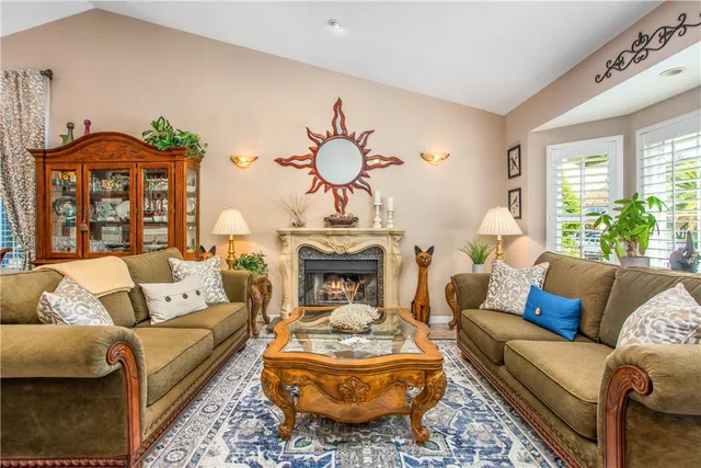 a living room with furniture fireplace and a large window