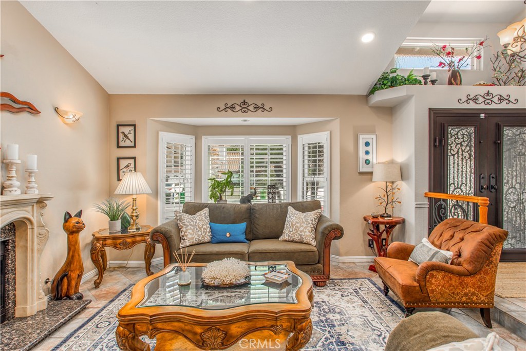 16455 Lake Knoll Parkway Riverside, CA 92503 - Photo 6 of 59 a living room with furniture fireplace and a large window