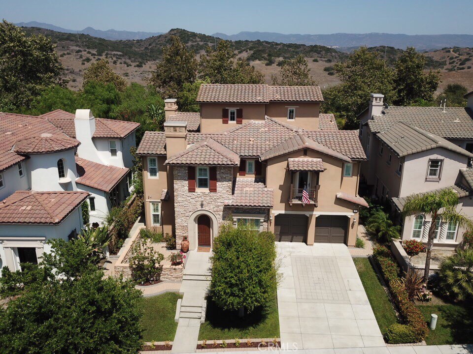 an aerial view of a house with a yard