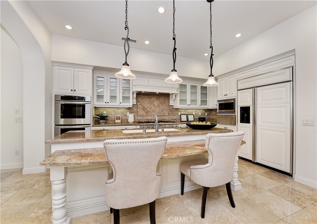 10 Elissa Lane Ladera Ranch, CA 92694 - Photo 4 of 23 a kitchen with kitchen island granite countertop a sink a counter space stainless steel appliances and cabinets