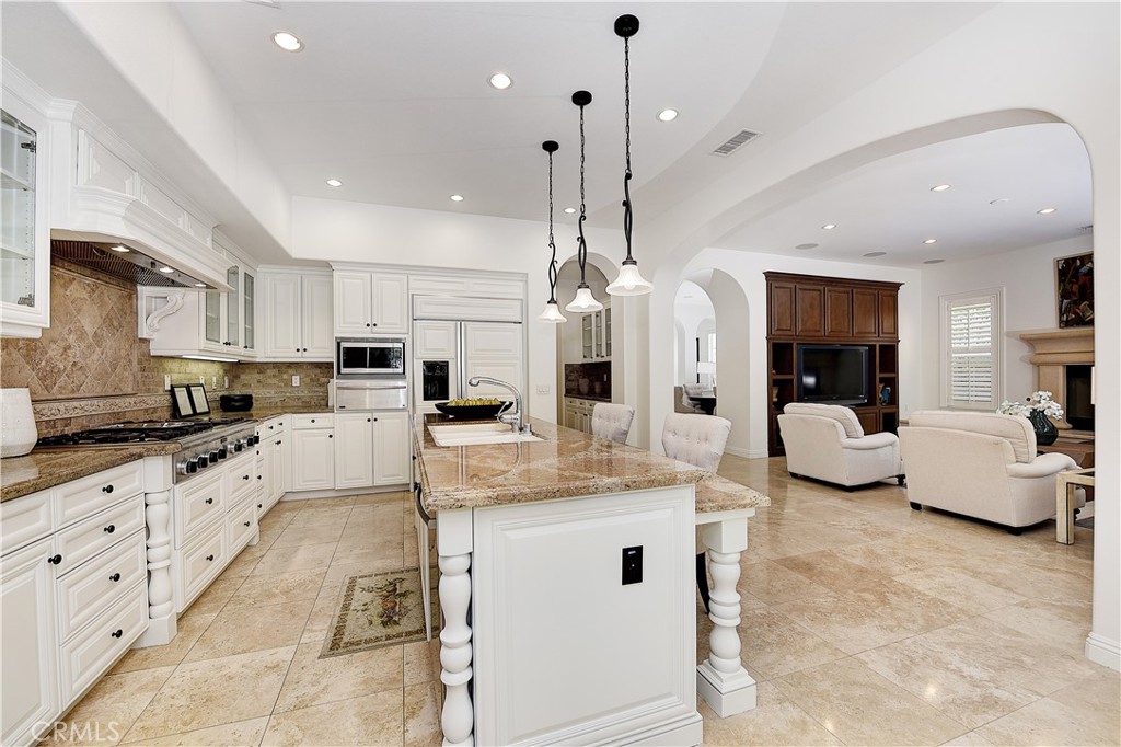 10 Elissa Lane Ladera Ranch, CA 92694 - Photo 6 of 23 a large kitchen with stainless steel appliances kitchen island granite countertop a refrigerator and a counter top space