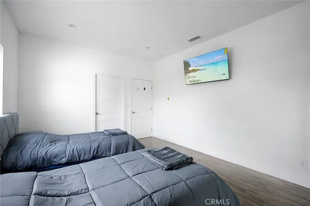 a bedroom with a bed and a painting on the wall