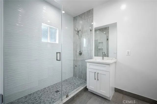 a bathroom with a shower and a sink