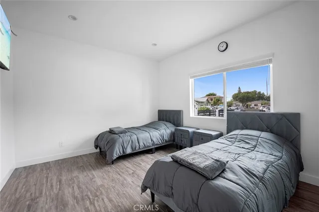 a bedroom with two beds and a night stand