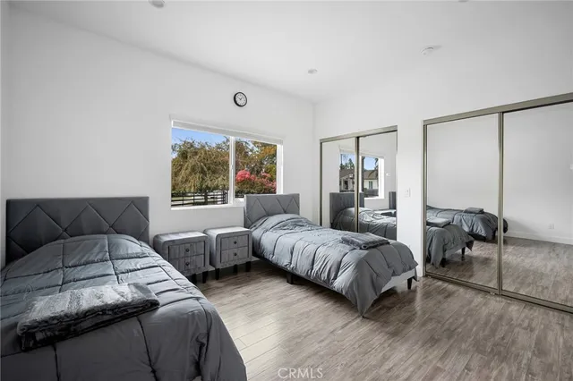 a bedroom with two beds and a large window