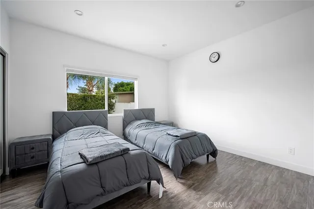 a bedroom with two beds and a large window
