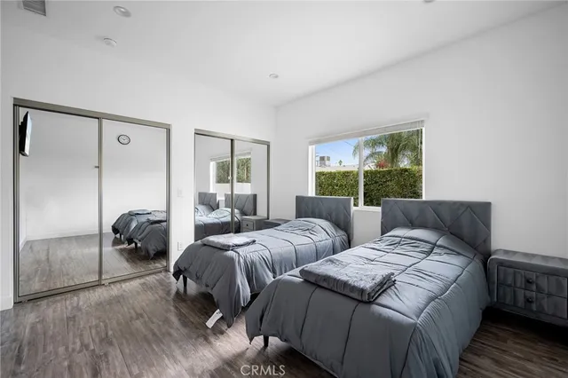 a bedroom with two beds and a window