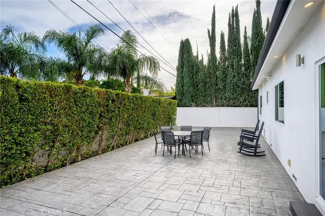 a backyard of a house with outdoor seating