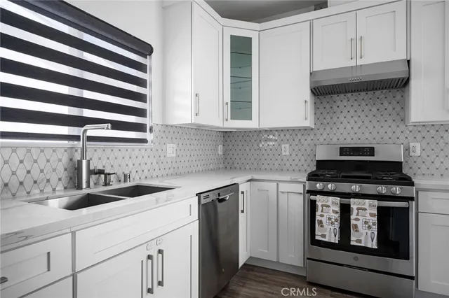 a kitchen with a sink stove and cabinets