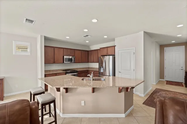 a view of kitchen with center island stove and wooden floor