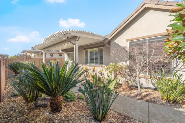 a front view of a house with a garden