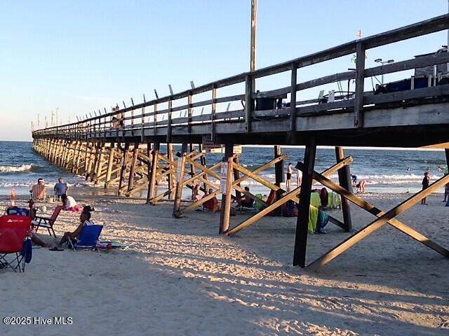 223 Clubhouse Road, Unit 5 Sunset Beach, NC 28468 - Photo 32 of 35 People gather under the pier to enjoy the beach