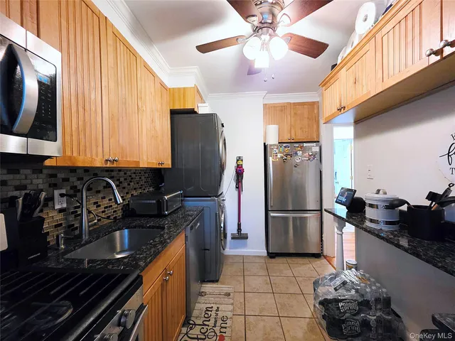 a kitchen with a sink appliances and cabinets