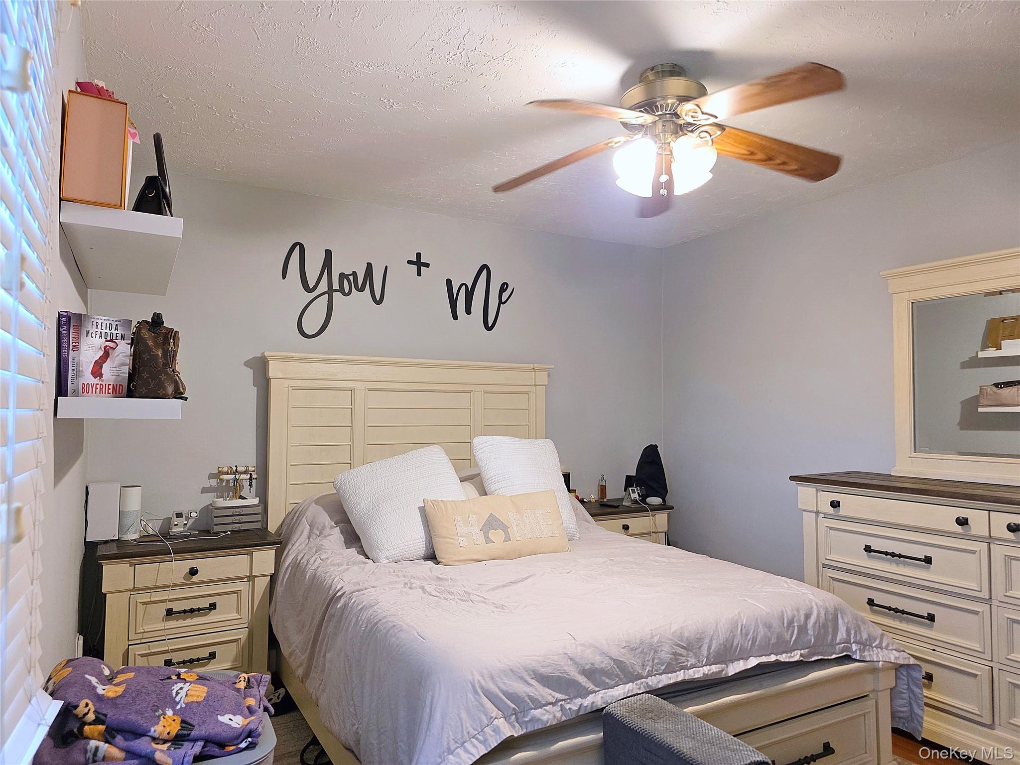 219-12 75th Avenue, Unit LOWR Queens, NY 11364 - Photo 14 of 22 a bedroom with a bed and a chandelier