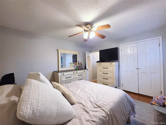 a bedroom with furniture and a flat screen tv