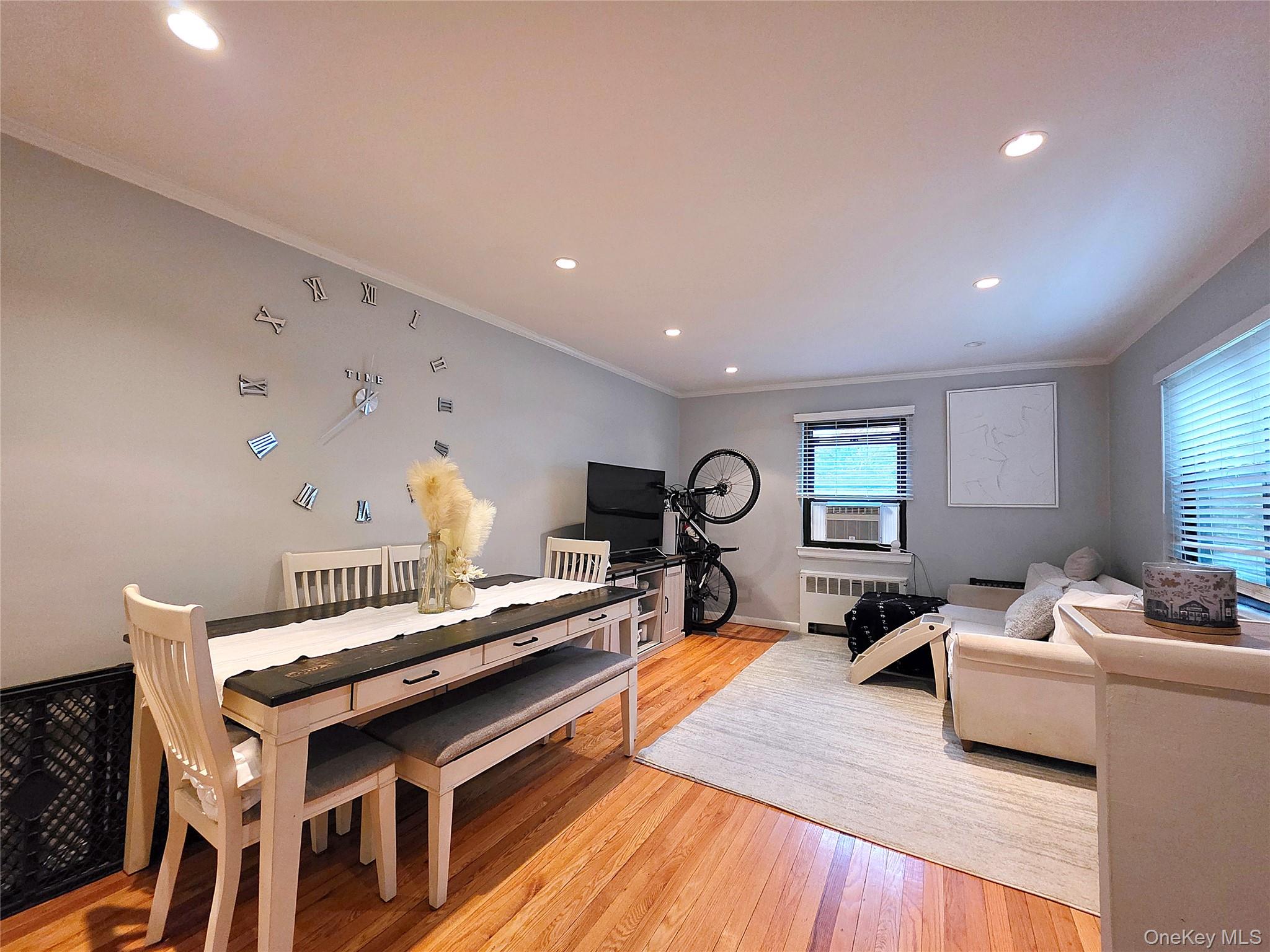 219-12 75th Avenue, Unit LOWR Queens, NY 11364 - Photo 3 of 22 a living room with furniture and a wooden floor