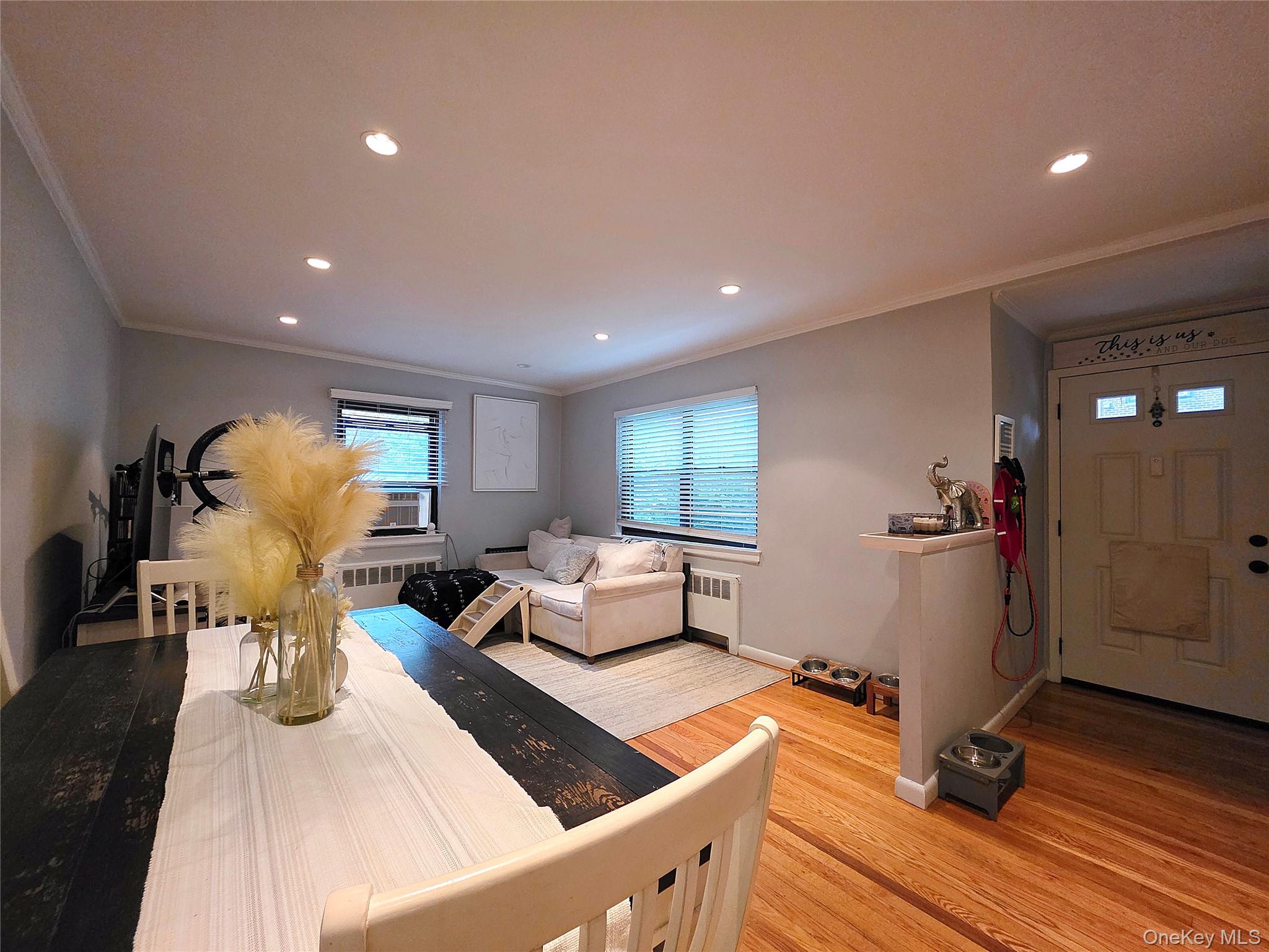 219-12 75th Avenue, Unit LOWR Queens, NY 11364 - Photo 5 of 22 a living room with furniture and a wooden floor