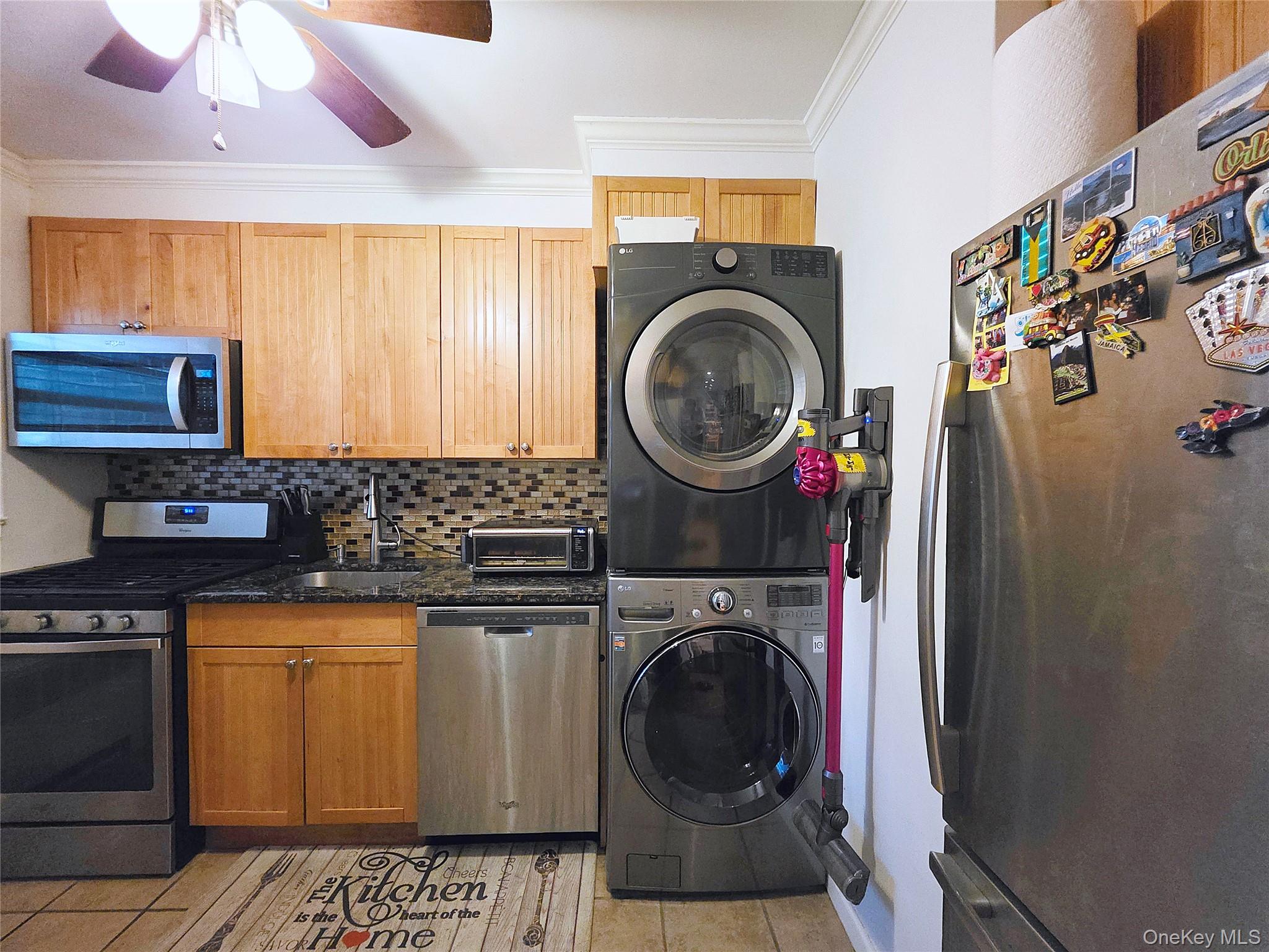 219-12 75th Avenue, Unit LOWR Queens, NY 11364 - Photo 9 of 22 a utility room with sink dryer and washer