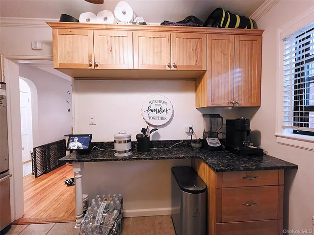 a kitchen with granite countertop a sink a stove and cabinets