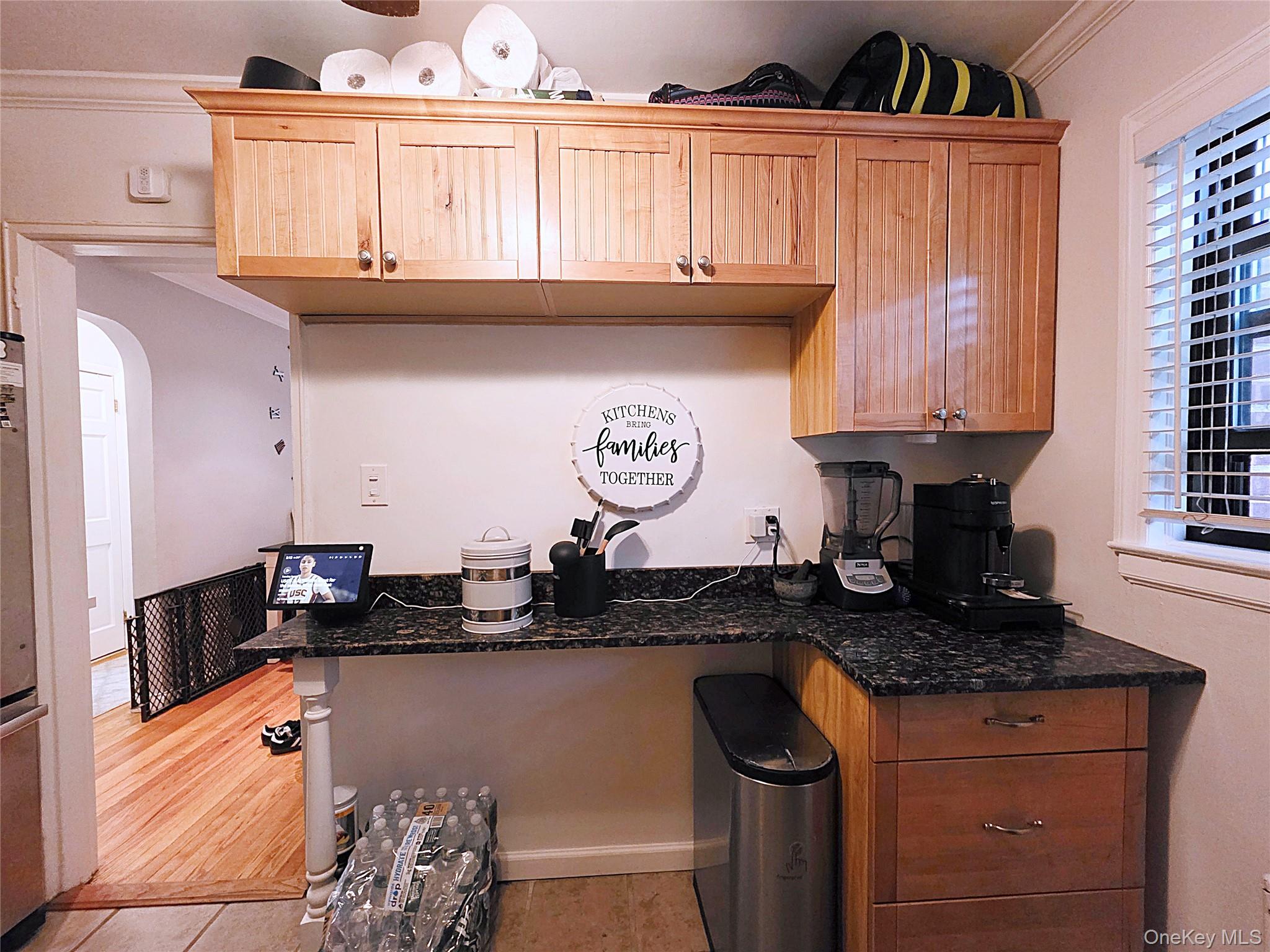 219-12 75th Avenue, Unit LOWR Queens, NY 11364 - Photo 10 of 22 a kitchen with granite countertop a sink a stove and cabinets