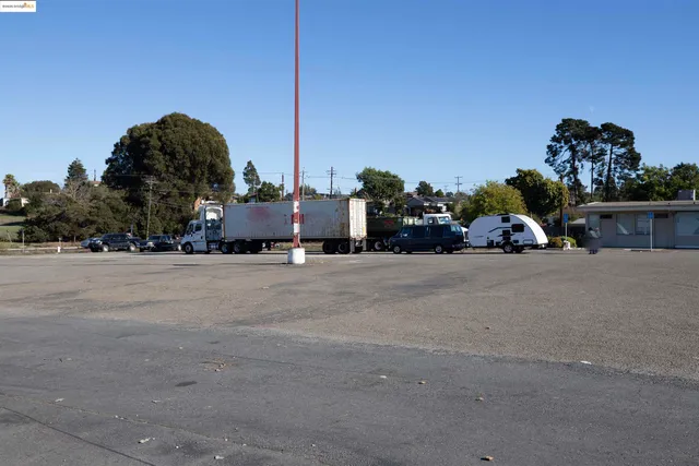 a view of street with a car parked on the road