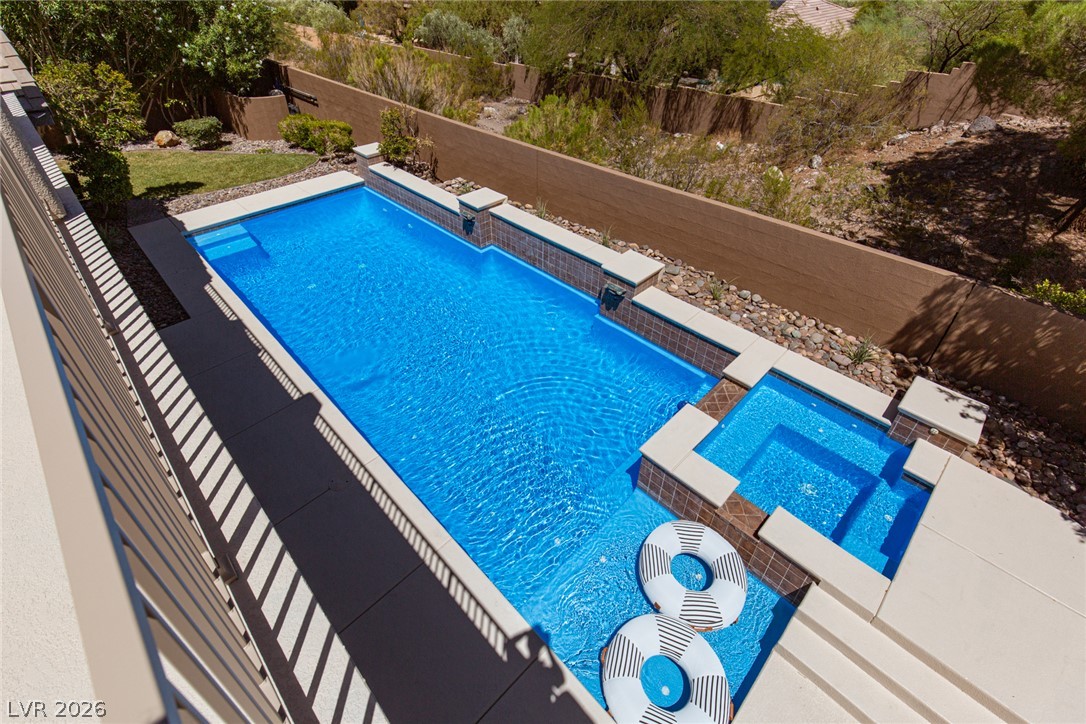22 Douglas Grove Road Henderson, NV 89052 - Photo 66 of 72 A refreshing in-ground pool with an integrated spa beckons, perfect for cooling off or unwinding under the sun.