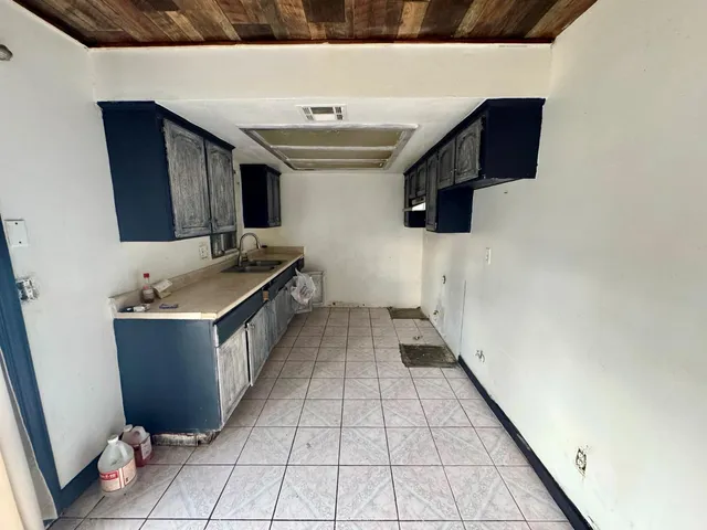 a kitchen with a sink and cabinets