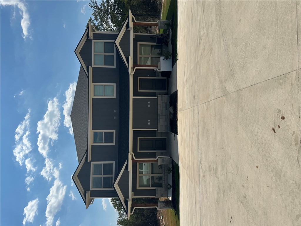 11144-11142 Stillwater Road College Station, TX 77845 - Photo 1 of 22 View of front of home with covered porch and a shingled roof