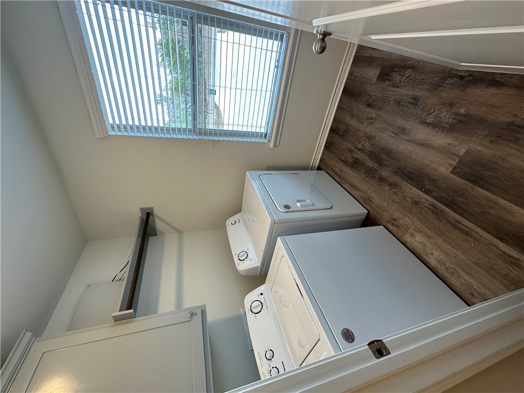 11144-11142 Stillwater Road College Station, TX 77845 - Photo 13 of 22 Laundry room with dark wood-type flooring, independent washer and dryer, and cabinet space