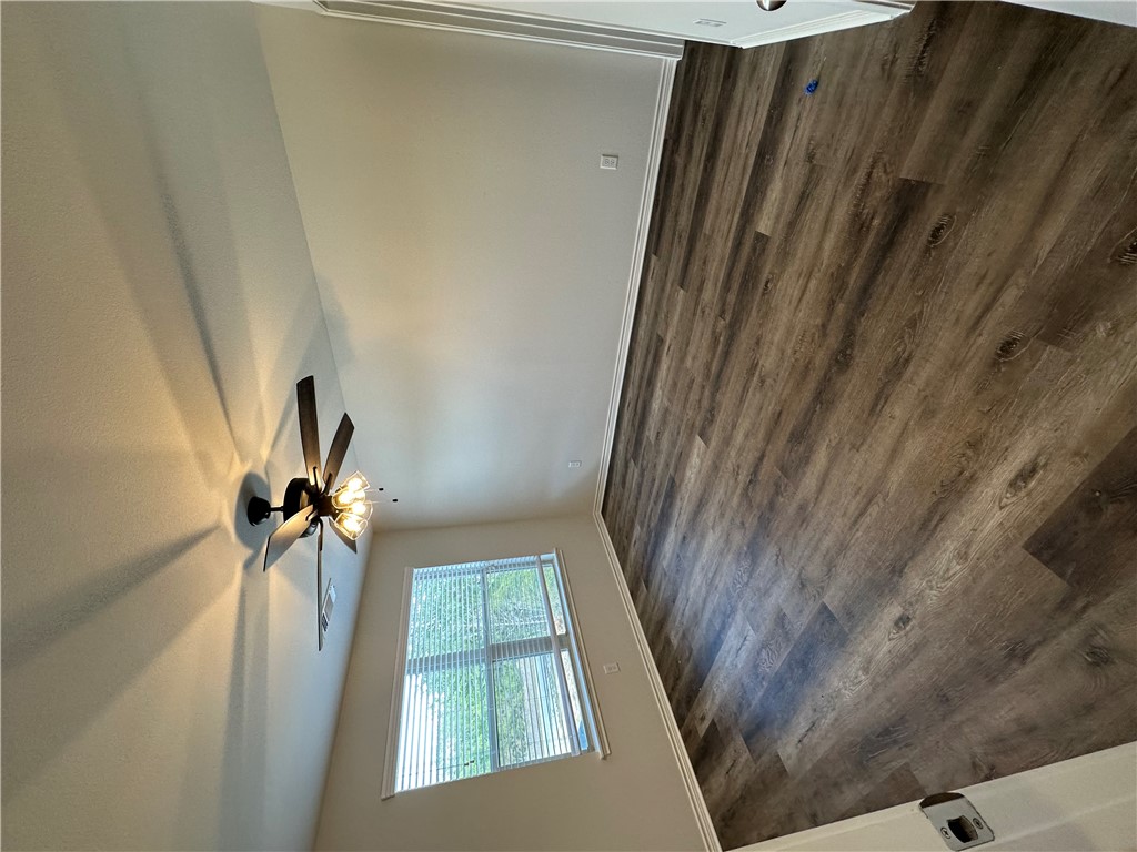 11144-11142 Stillwater Road College Station, TX 77845 - Photo 14 of 22 Spare room featuring dark wood-type flooring and ceiling fan