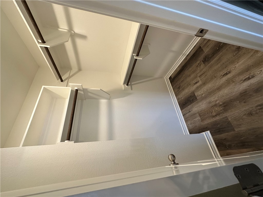 11144-11142 Stillwater Road College Station, TX 77845 - Photo 16 of 22 Walk in closet featuring dark wood-type flooring