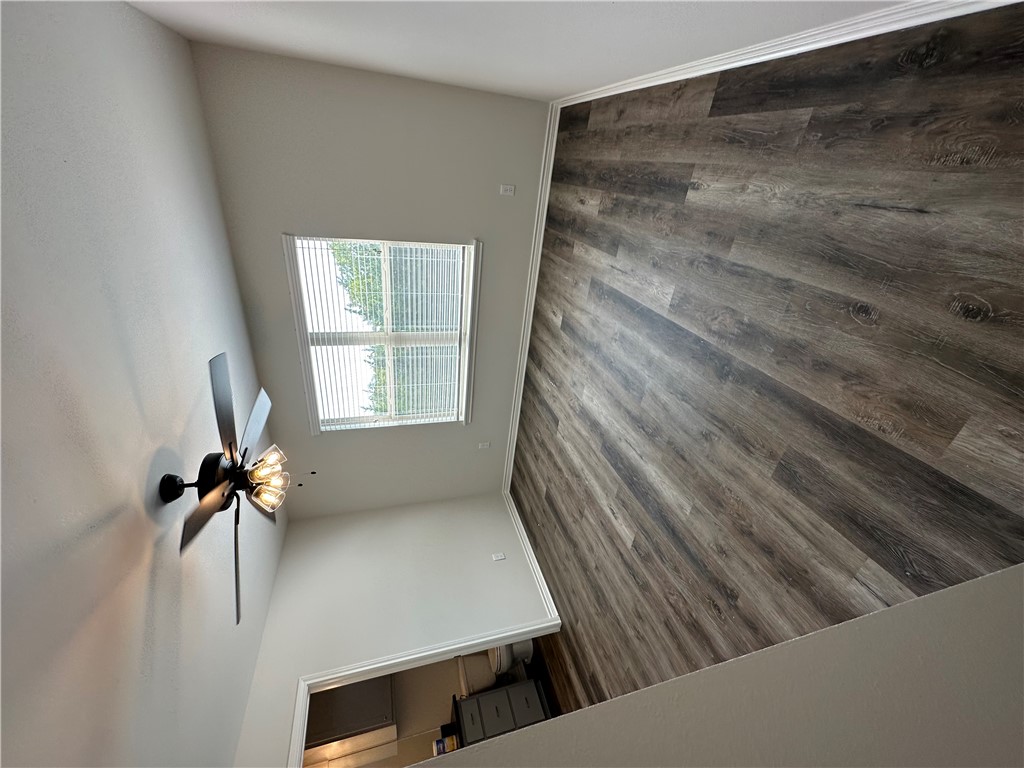 11144-11142 Stillwater Road College Station, TX 77845 - Photo 17 of 22 Empty room featuring dark wood-type flooring and ceiling fan
