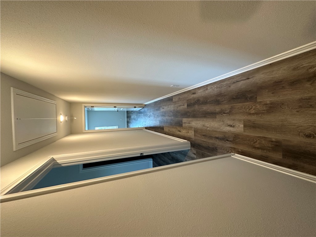 11144-11142 Stillwater Road College Station, TX 77845 - Photo 19 of 22 Hallway with attic access and dark wood-type flooring