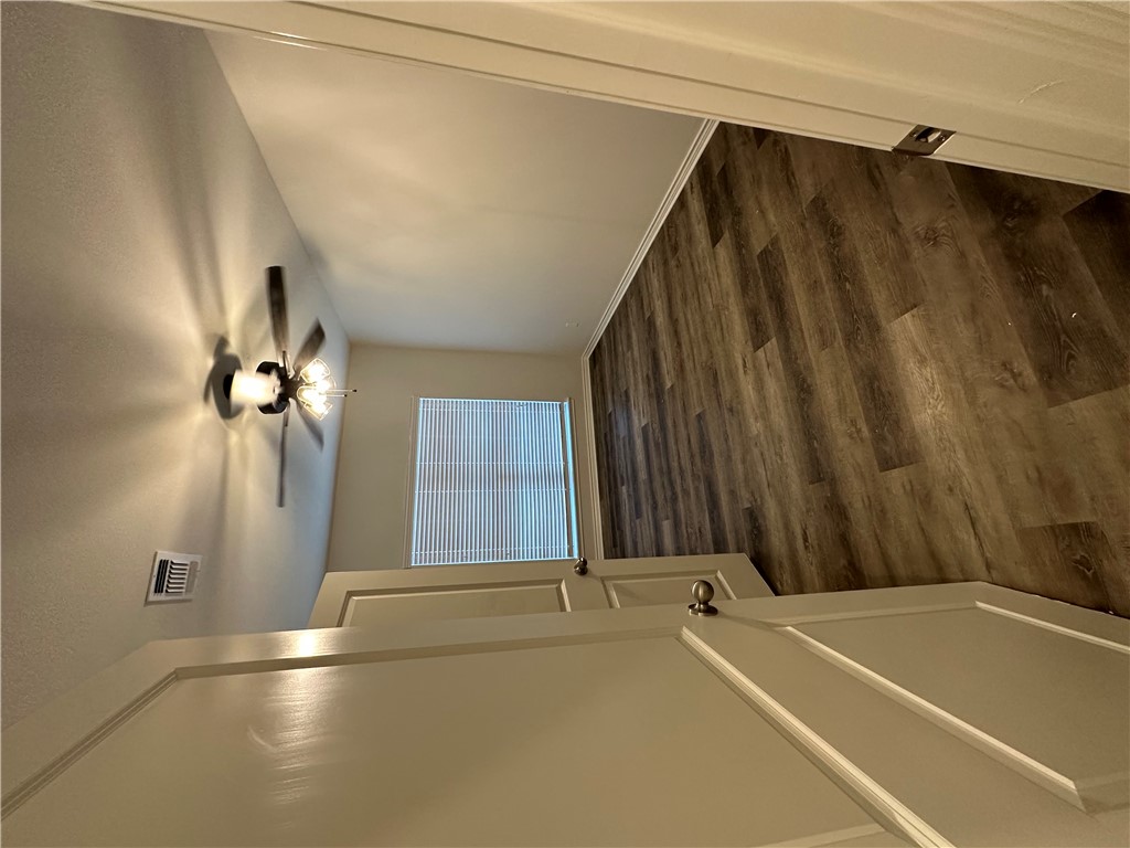 11144-11142 Stillwater Road College Station, TX 77845 - Photo 10 of 22 Unfurnished room featuring dark wood-style flooring and a ceiling fan