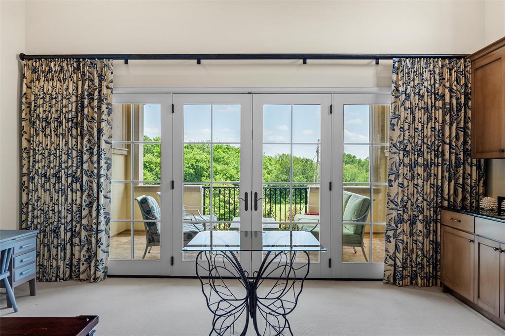 4101 Howard Road Waxahachie, TX 75165 - Photo 26 of 40 Tucked away in the guest wing, the second floor family room provides a wealth of potential uses, with a wall of windows leading to the covered patio and views of the expansive, lush grounds.