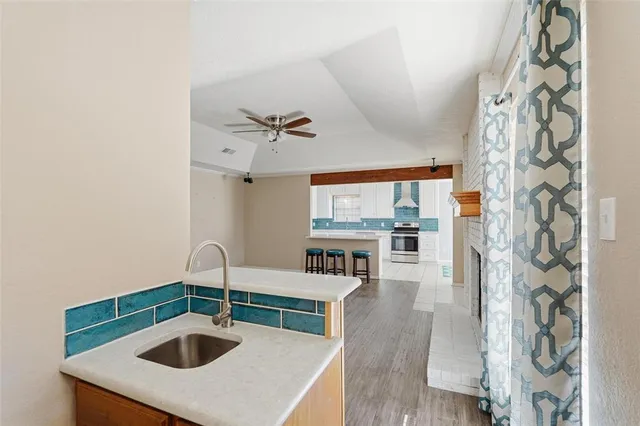 a kitchen with a sink a stove and cabinets