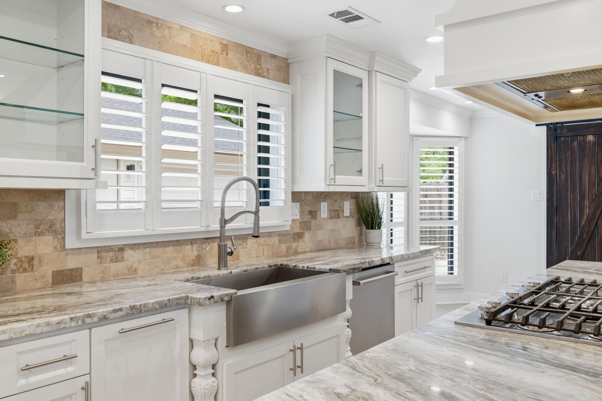 14 Ridgeline Court Spring, TX 77381 - Photo 15 of 40 Another view of this stunning kitchen with high-end stainless steel Appliances, Farmhouse Sink, & fixtures. SlidingBarn doors to the right of the photo lead to the Laundry Room , Half Bath and outside Entry