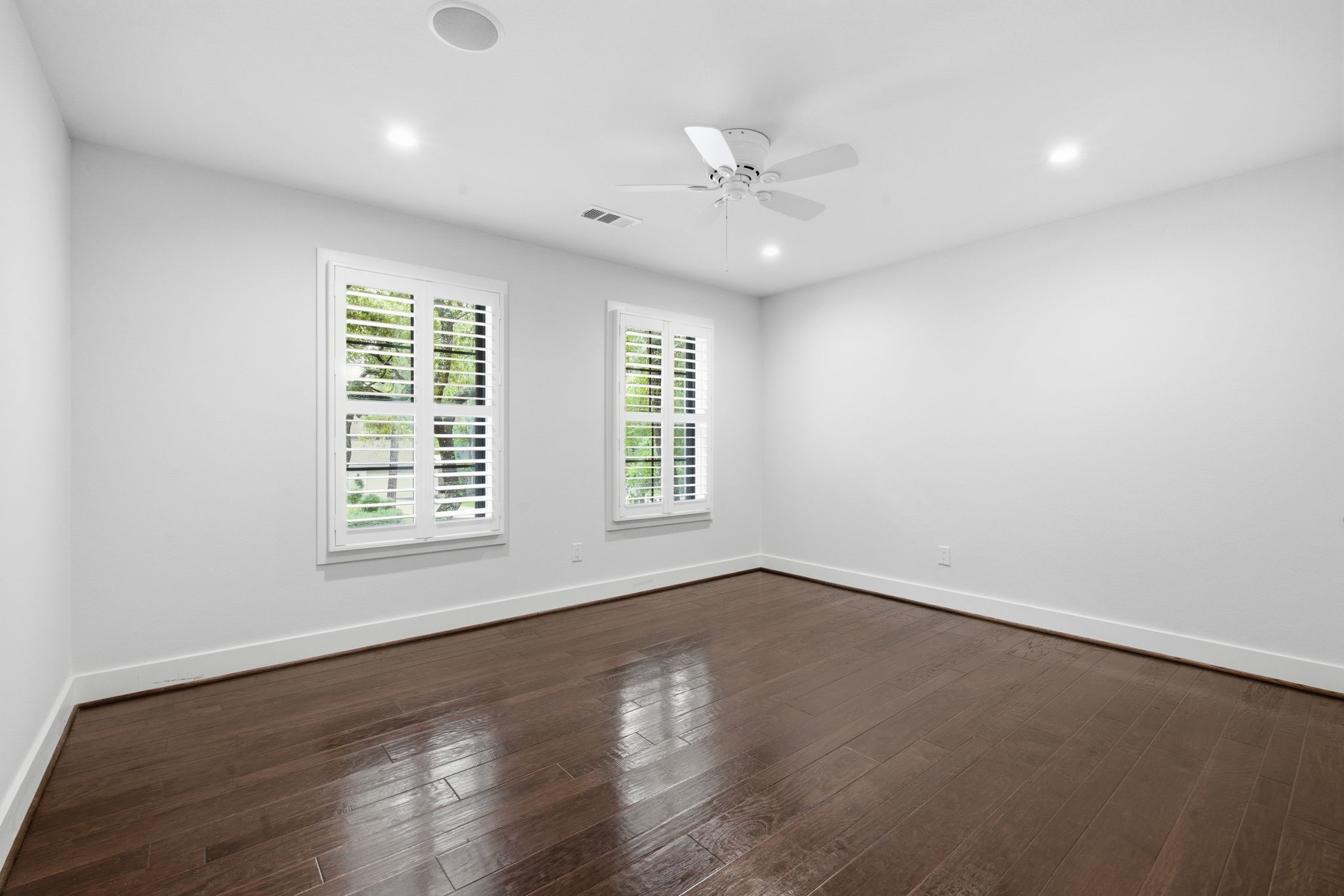 14 Ridgeline Court Spring, TX 77381 - Photo 26 of 40 Secondary Bedroom 2 with Wood flooring, Ceiling fan and plantation shutters