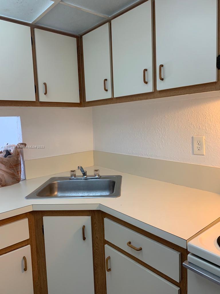 Yolanda Villas Condominiums Miami, FL 33126 - Photo 9 of 10 a view of a kitchen with a sink and cabinets