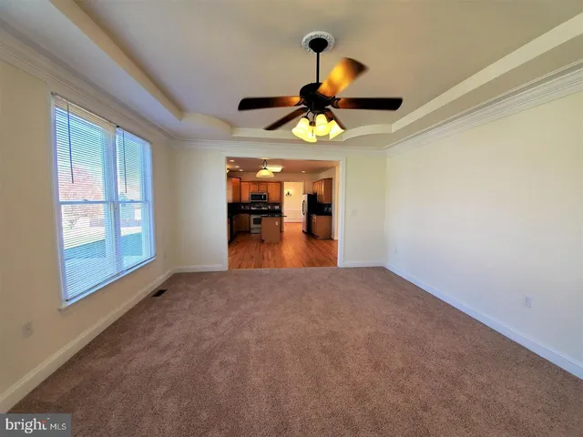 a view of a room with a hanging light and furniture
