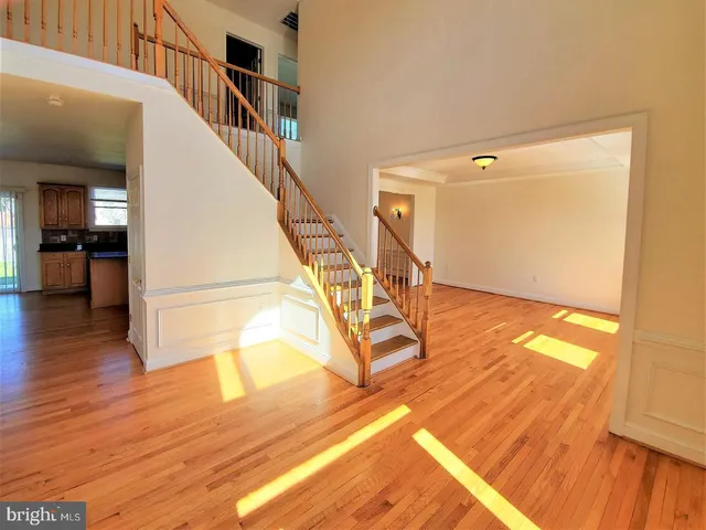 a view of entryway and hall with wooden floor