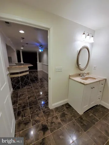 a bathroom with a sink mirror and vanity