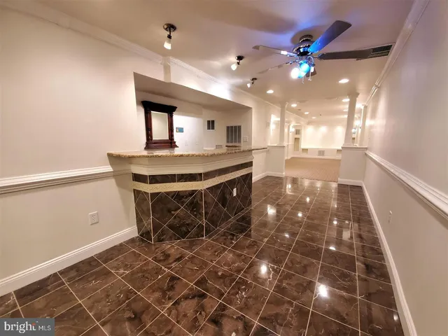 a kitchen with kitchen island a counter space a sink and appliances