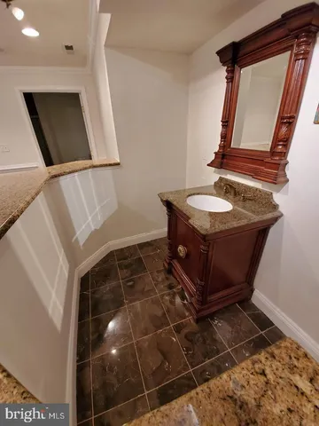 a bathroom with a sink toilet and mirror