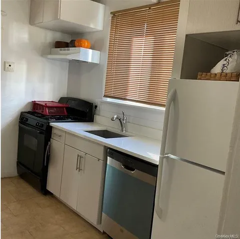 a kitchen with a sink and a refrigerator