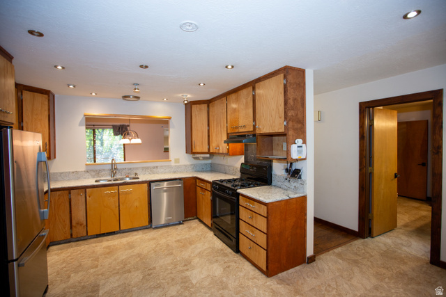 1500 Sumac Drive Logan, UT 84321 - Photo 19 of 42 Kitchen featuring light wood cabinetry, granite countertops, and stainless steel appliances including a refrigerator and dishwasher
