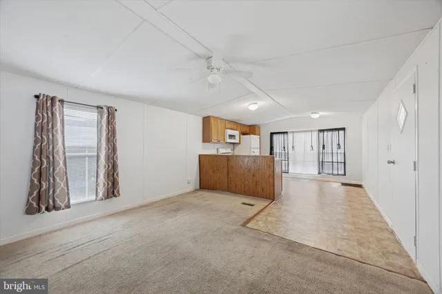 an empty room with windows and cabinet