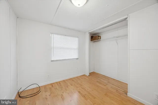 a view of a room with a wooden floor and white walls