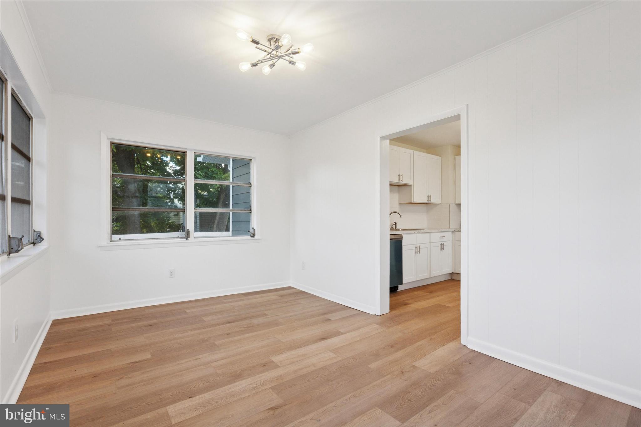 260 Weber Avenue Ewing, NJ 08638 - Photo 13 of 25 a view of empty room with a window and wooden floor