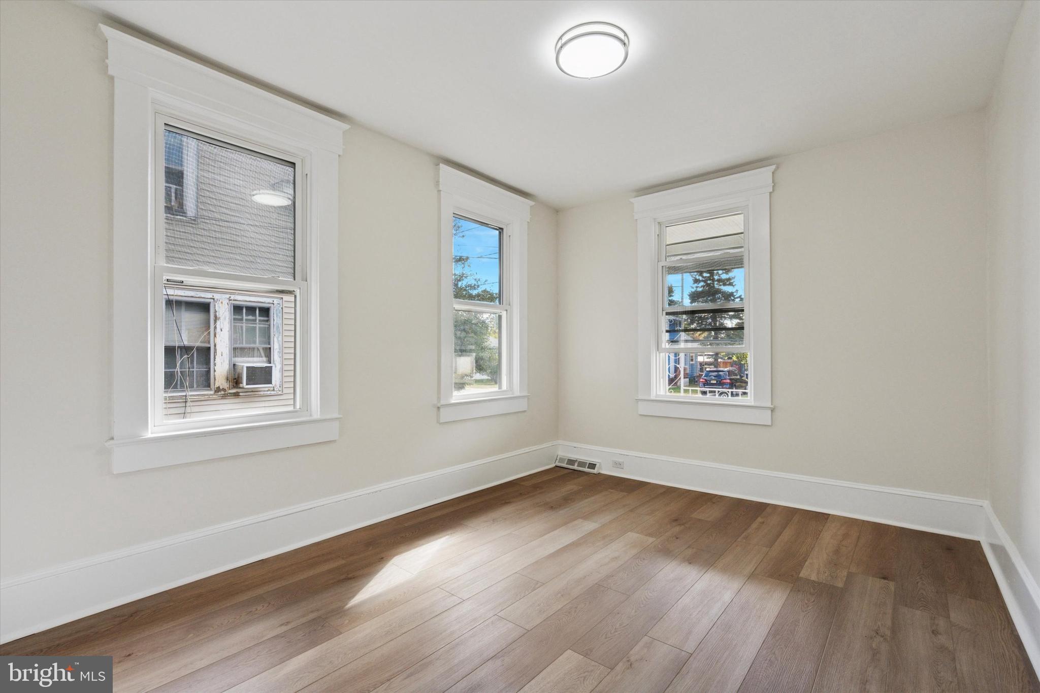 260 Weber Avenue Ewing, NJ 08638 - Photo 14 of 25 an empty room with wooden floor and windows